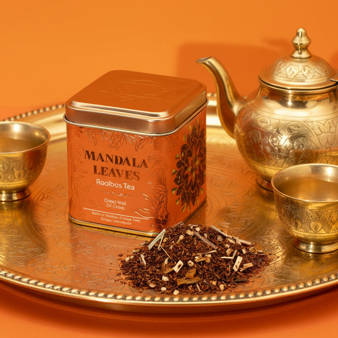 Tin of Rise & Sage Rooibos Eco Great Wall of China tea with earthy, calming design, featuring rooibos leaves, orange peel, ginger and lemongrass styled in a quiet ritual setting.